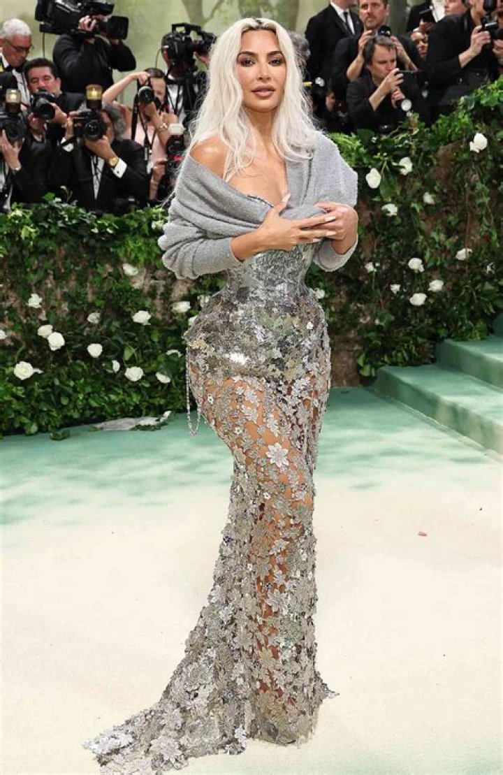 Kim Kardashian looked down at her snakeskin boots while walking