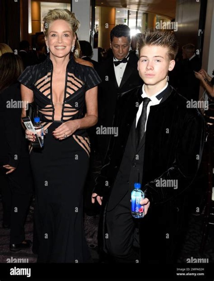 Sharon Stone, left, and Roan Joseph Bronstein pose for photographers upon arrival at the amfAR Cinema Against AIDS benefit the during the 74th Cannes international film festival, Cap d'Antibes, southern France 2021 amfAR Arrivals, Cannes, France - 16 Jul 2021